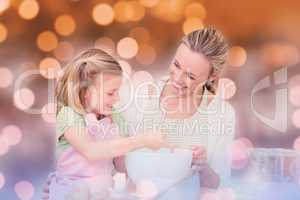 Composite image of mother and daughter having fun in the kitchen