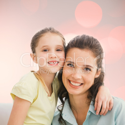 Composite image of cute mother and daughter smiling at camera