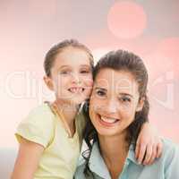 Composite image of cute mother and daughter smiling at camera