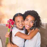 Portrait of a pretty mother sitting  with her daughter holding roses