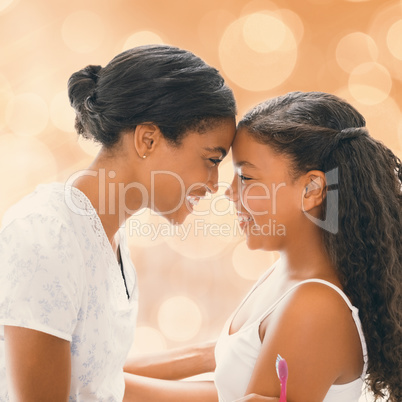 Portrait of mother and daughter holding each other