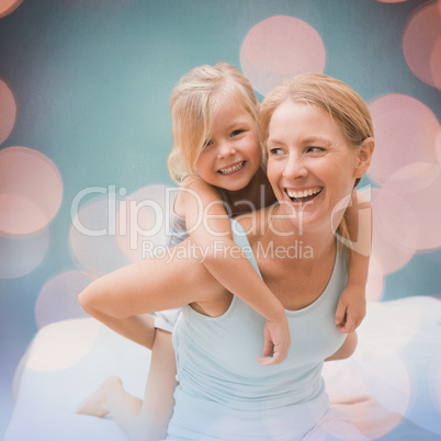 Composite image of cute little girl and mother on bed