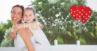 Composite image of Mother and daughter holding each other