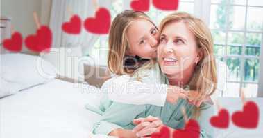 Composite image of Mother and daughter holding each other