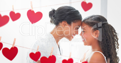 Composite image of mother and daughter looking each other