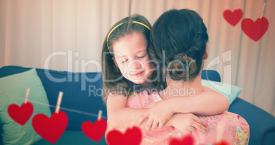 Composite image of Mother and daughter holding each other