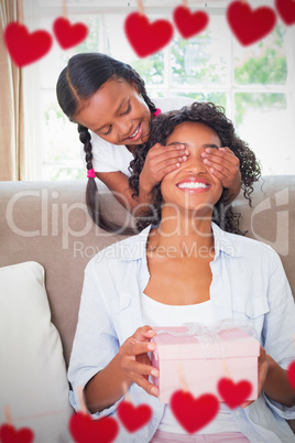Composite image of daughter hiding mothers eyes