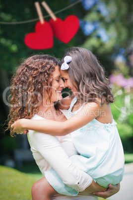 Composite image of Mother and daughter holding each other