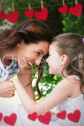 Composite image of mother and daughter looking each other