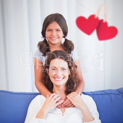 Composite image of hearts hanging on a line