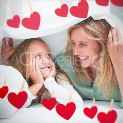 Composite image of hearts hanging on a line