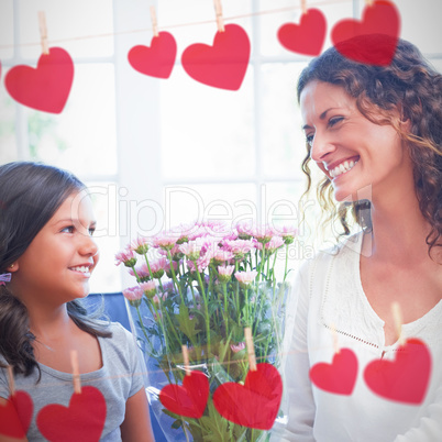 Composite image of hearts hanging on a line