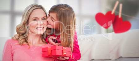 Composite image of smiling mother being kissing by daughter