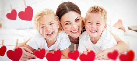 Composite image of laughing children playing with their mother l