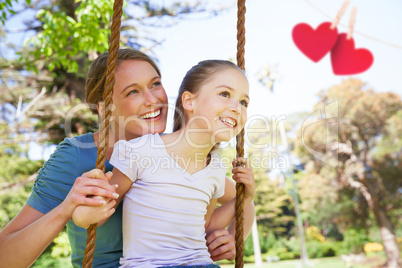 Composite image of hearts hanging on a line