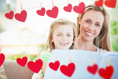 Composite image of hearts hanging on a line