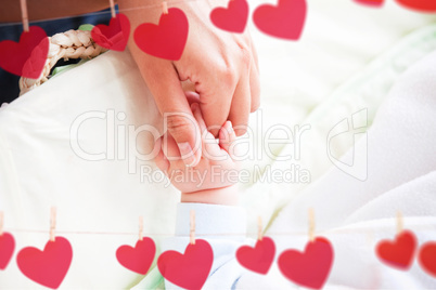 Composite image of hearts hanging on a line