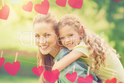 Composite image of hearts hanging on a line