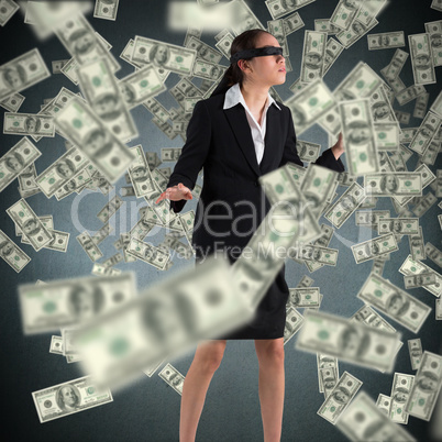 Composite image of blindfolded businesswoman with hands out