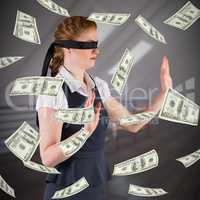 Composite image of redhead businesswoman in a blindfold