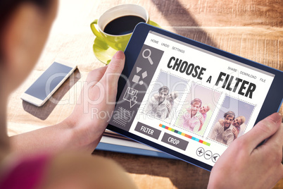 Composite image of woman using tablet pc