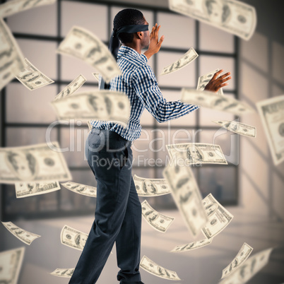 Composite image of blindfolded businessman with arms out