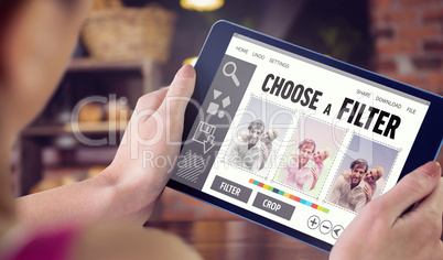 Composite image of woman using tablet pc