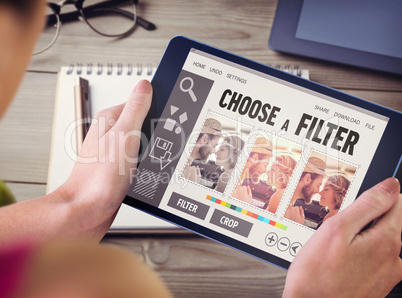 Composite image of woman using tablet pc