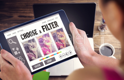 Composite image of woman using tablet pc