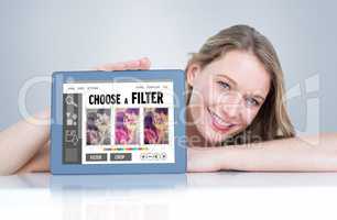Composite image of woman showing tablet pc