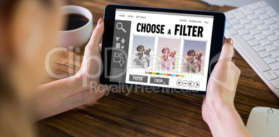 Composite image of woman using tablet pc