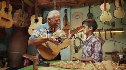11-Old Man Grandpa Teaching Boy Grandchild Playing Guitar