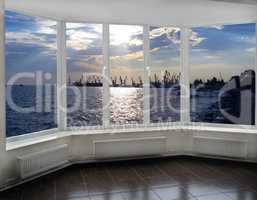 window with view of evening sea port docks and cranes