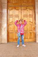 Schoolgirl posing before big wooden door