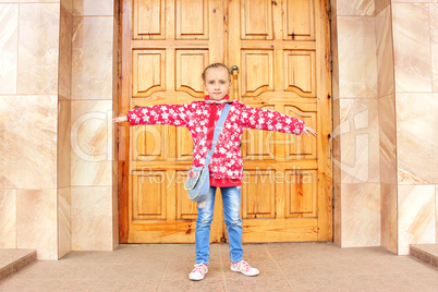 Schoolgirl before big wooden door