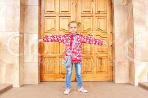 Schoolgirl before big wooden door