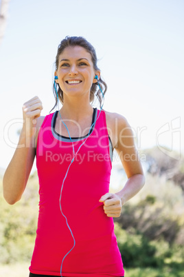 Woman jogging while listening to music