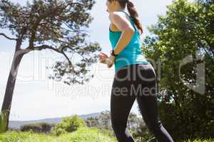 Fit smiling woman jogging