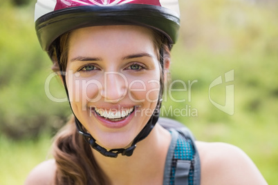 Smiling woman wearing a helmet