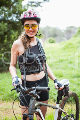 Smiling woman standing next to her bike