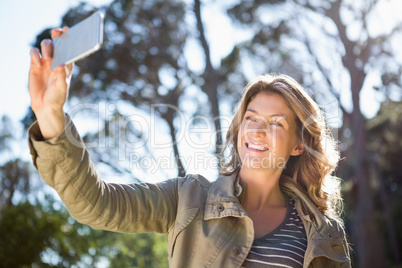 Smiling woman taking selfie