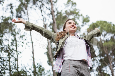 Smiling woman with arms up