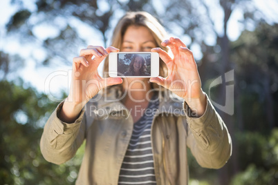 Smiling woman taking selfies