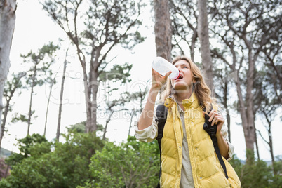 Woman drinking water while doing a break