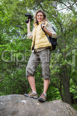 Smiling woman holding binoculars