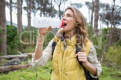 Woman drinking water while doing a break