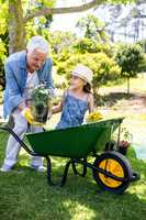 Grandfather and granddaughter holding flower pot