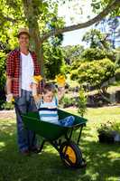 Father carrying his son in a wheelbarrow