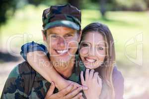 Happy soldier reunited with his partner in the park