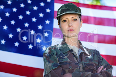 Soldier standing in front of american flag